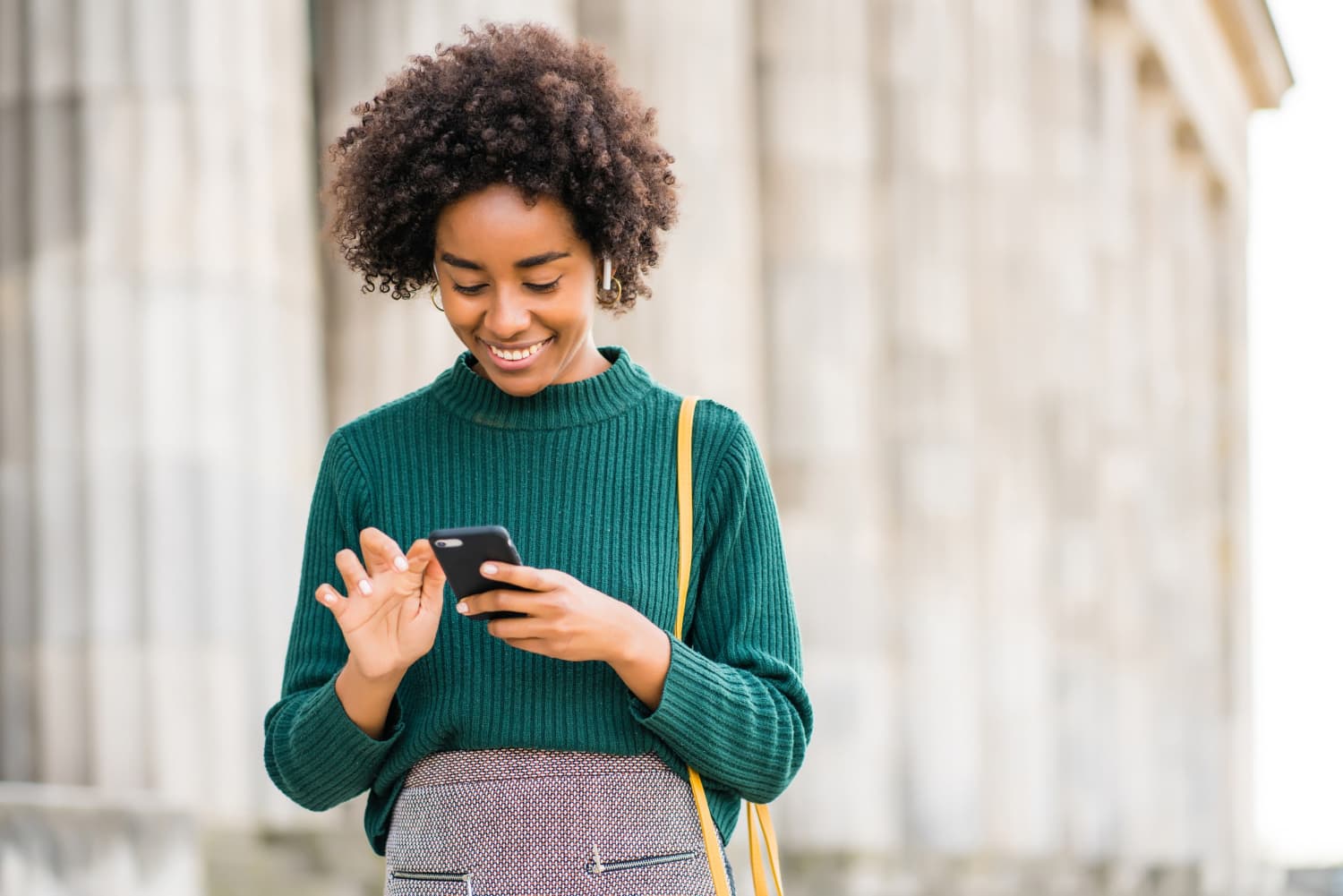 A SaukiPAY merchant checking payouts on her phone